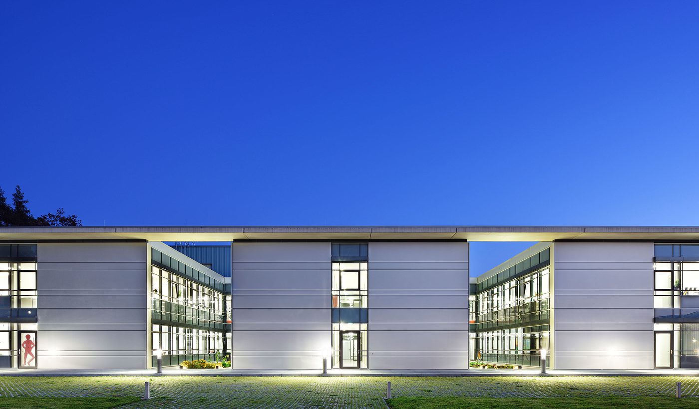 Neubau am Klinikum Nürnberg Süd in der Abenddämmerung mit beleuchteten Glasfugen